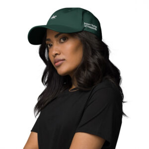 woman wearing a green hat with jesus christ embroidered on it